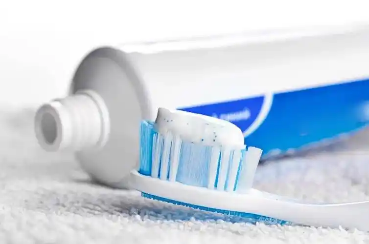 Business owner discussing toothpaste production samples with a manufacturer at a toothpaste factory