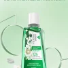 Clear green liquid of natural probiotic jasmine green tea mouthwash pouring from bottle Clear green liquid of natural probiotic jasmine green tea mouthwash pouring from bottle